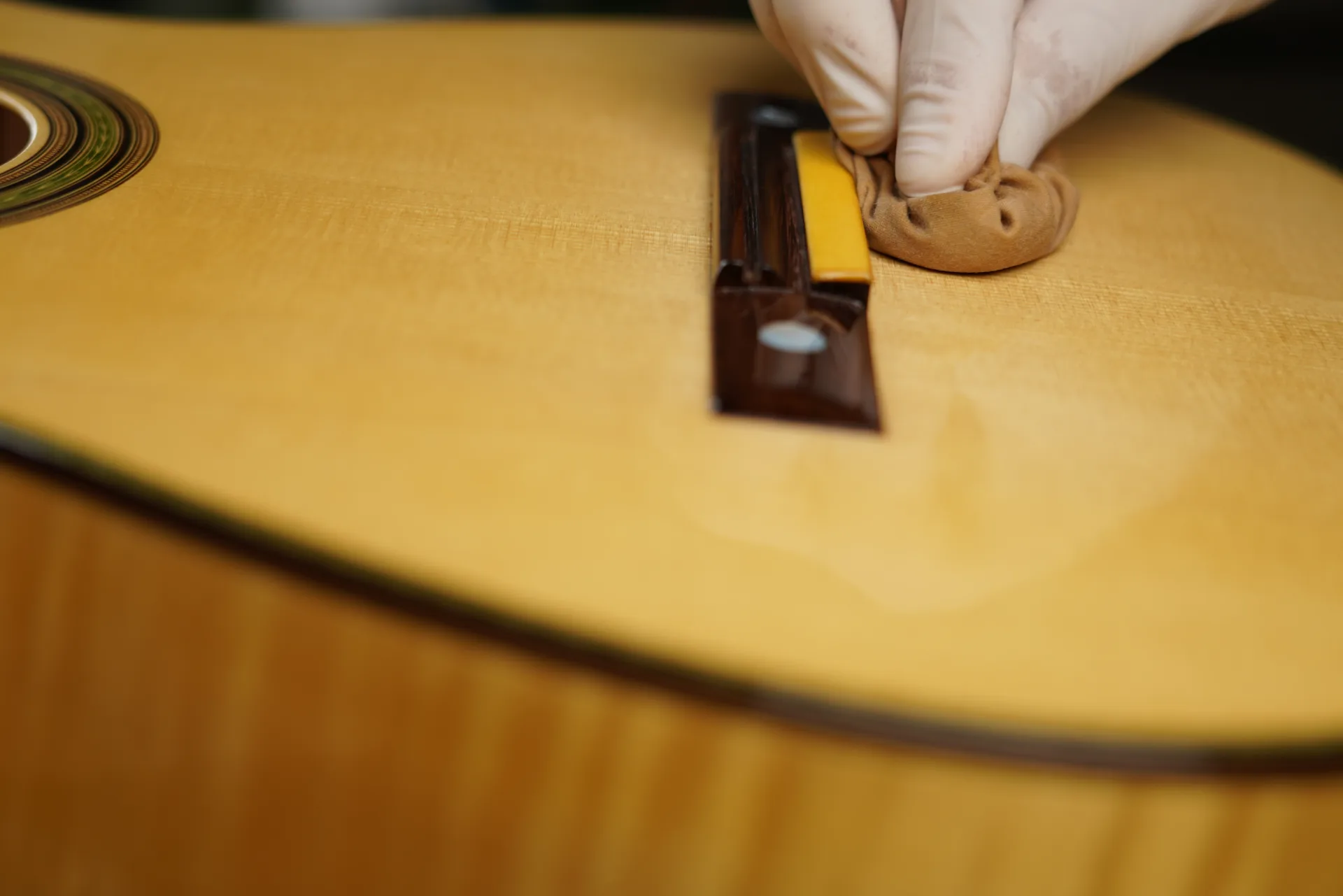 Difficult corners at the bridge and fingerboard — a soft section of cloth, varnish applied locally with the finger