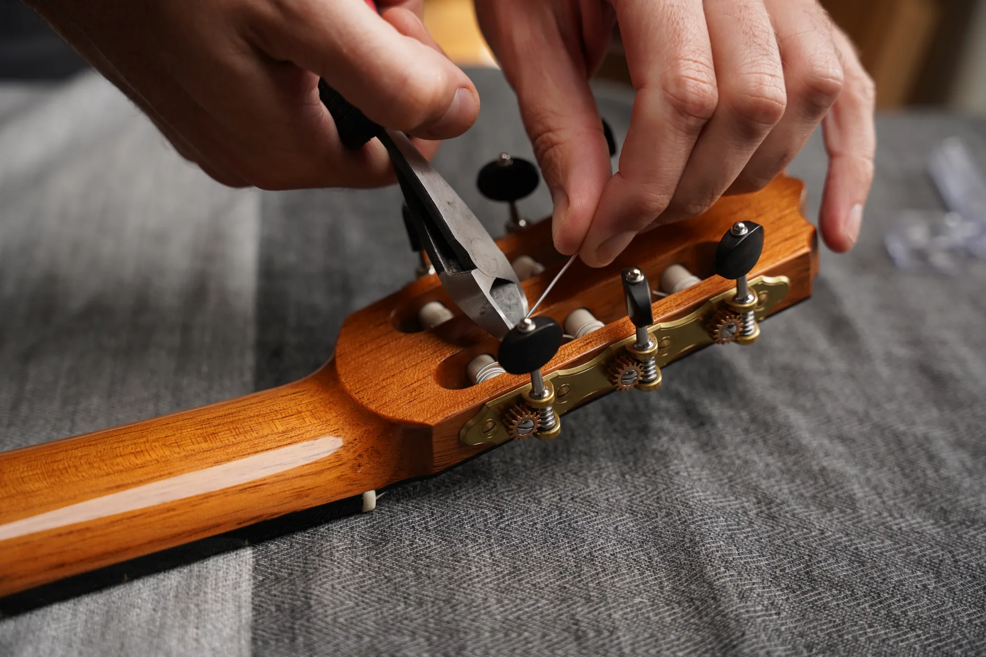 Carefully trim the excess string once at pitch — leave a short tail