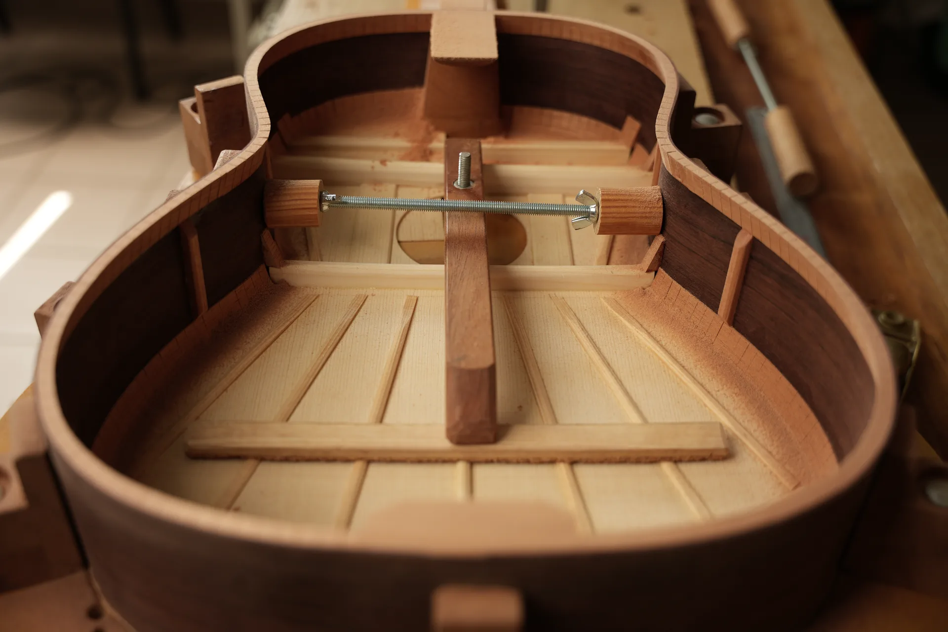 Inside view of the guitar body — bracing complete, ready for the back