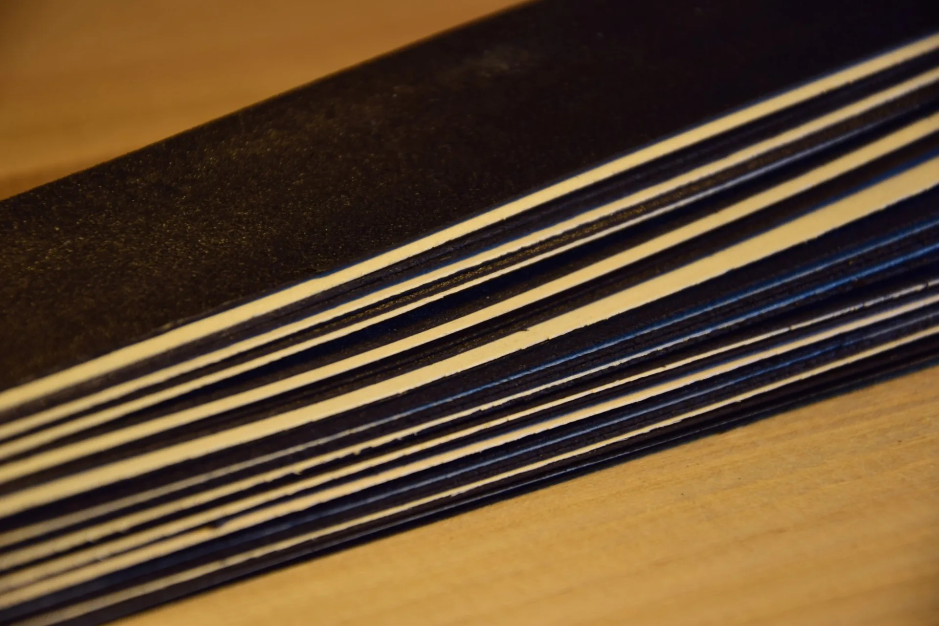 Stacks of contrasting colours — two black layers of 0.5mm for the background and 0.3mm maple for the herringbone motif