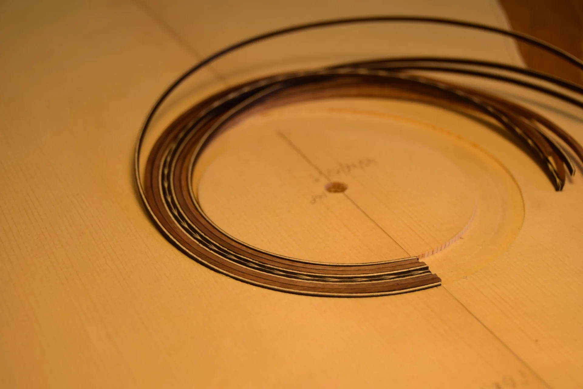 The bent herringbone motif ready to be inlaid into the soundboard rosette channel